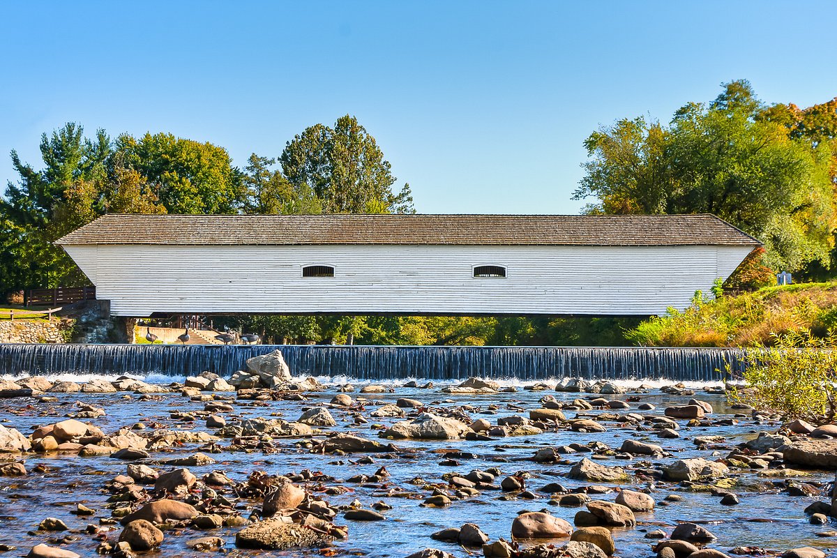 Elizabethton Covered Bridge over the Doe River with low dam and rocky shallows