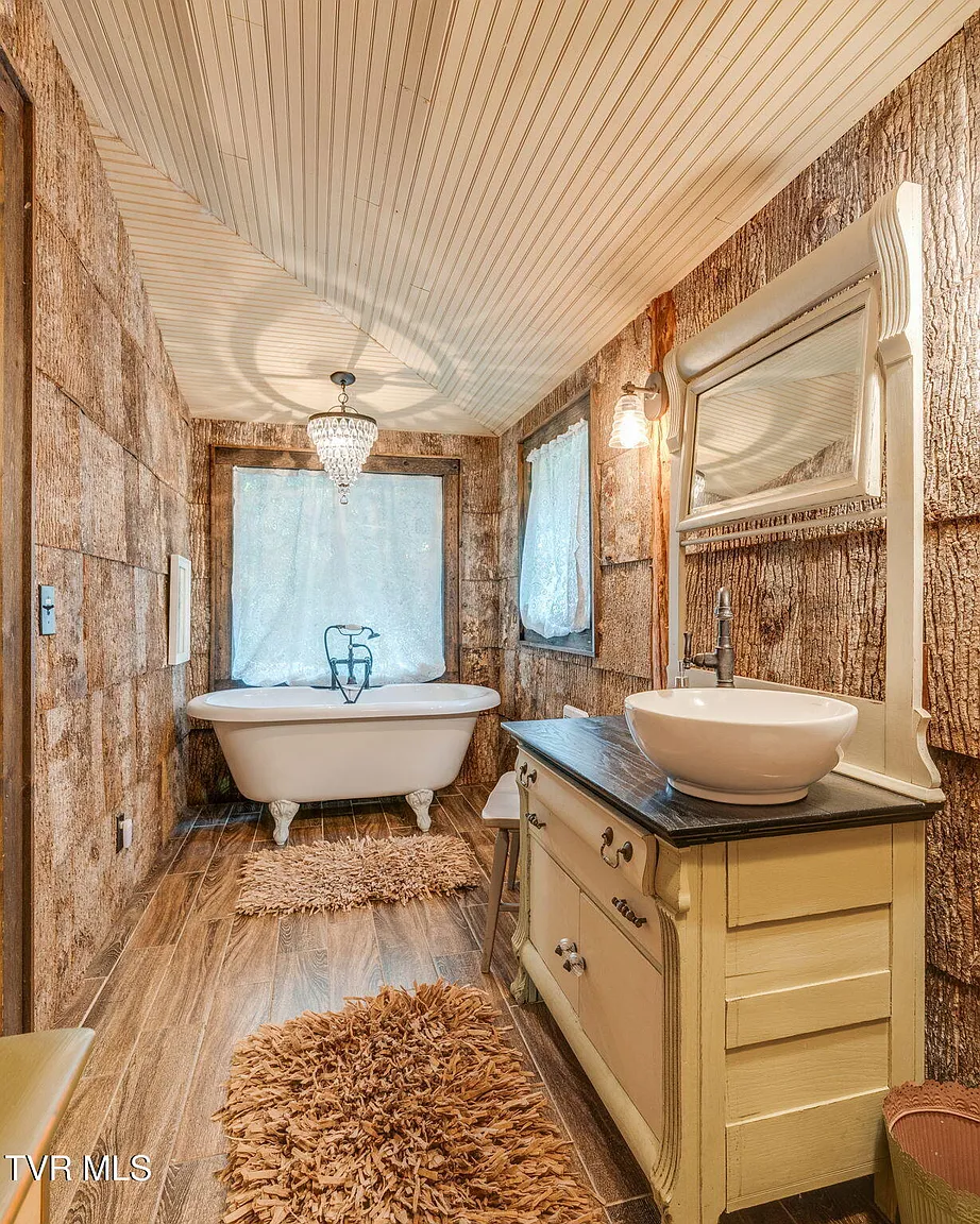 Bear cabin bathroom with clawfoot tub and vessel sink